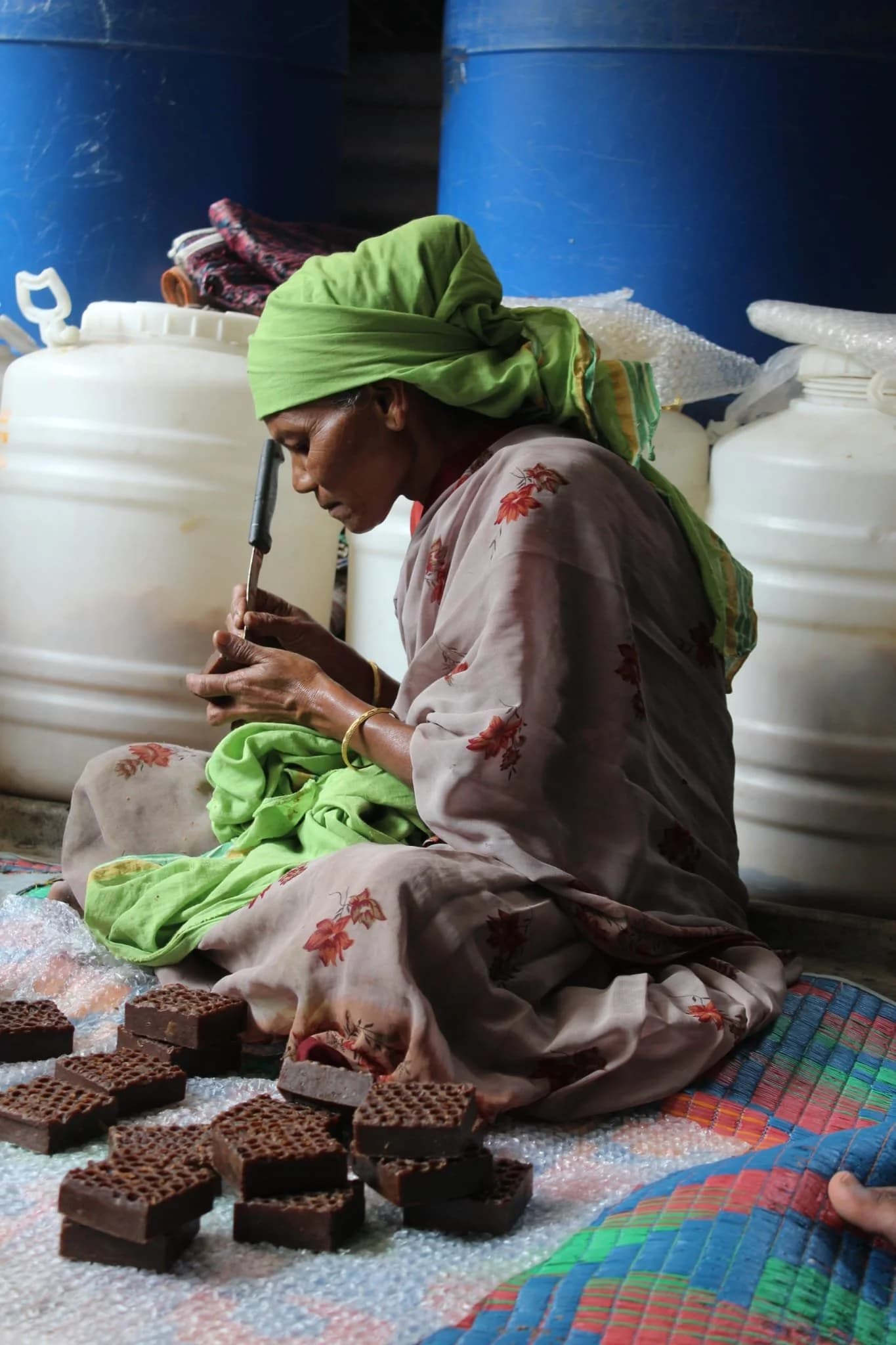 A tribal woman artisan preparing handcrafted beeswax skincare